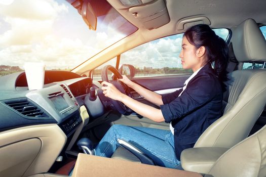 Young woman driving a car 