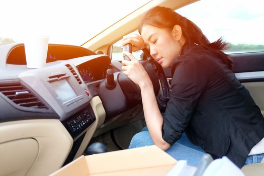 Tired young woman fall asleep in her car