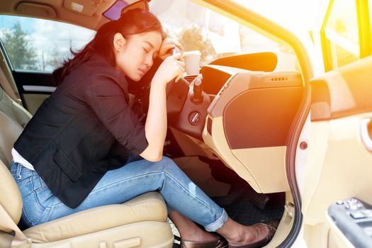 Tired young woman fall asleep in her car