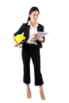 Young woman engineer holding a yellow helmet and reading construction documents on white background 