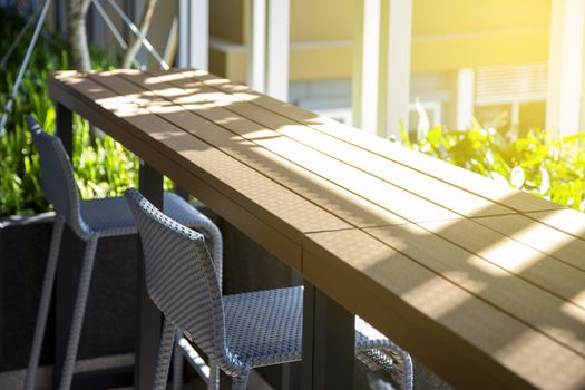 Empty chair and table at terrace with light