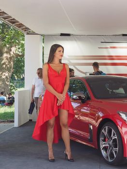 TURIN, ITALY - CIRCA JUNE 2019: Stand girl at Salone Auto di Torino (meaning Turin Motorshow), free outdoor car exhibition in Valentino park