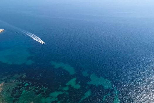 A boat floats on the blue sea. Spain's resorts.