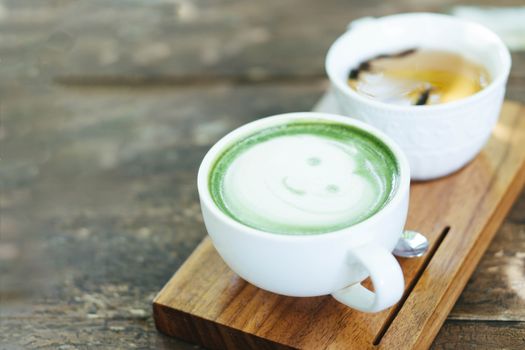 Closeup glass of matcha green tea shape on wood background with vintage color, selective focus