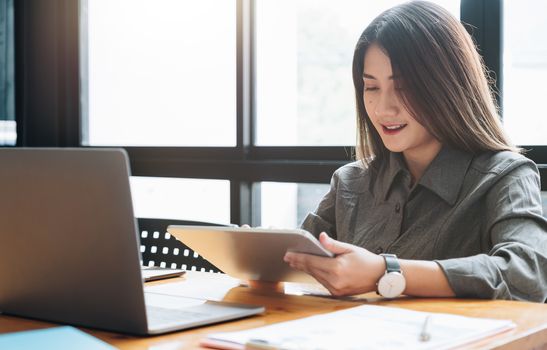 Young woman use tablet computer for business analyze.