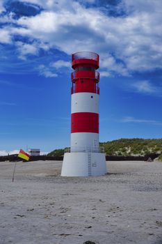 The red and white small Lighthouse on Island Dune - Heligoland - Germany with blue Sky