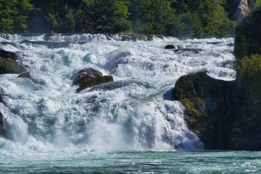 the famous rhine falls in the swiss near the city of Schaffhausen - sunny day and blue sky