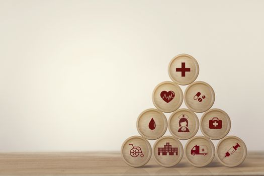 Healthcare concept about of health and medical insurance, Arranging block sphere stacking with icon health care medical on table wooden background.