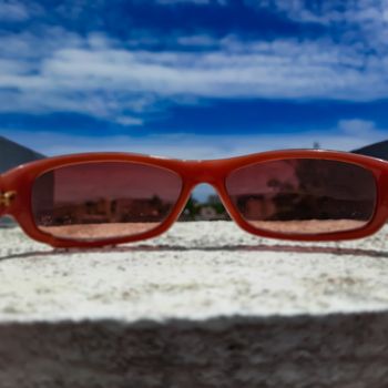 Chennai, India - July 3 2020: Red color glass placed in wall to see beautiful view of the sky from the glass lens