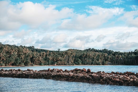 Coastline and stone at the sea with blue sky.