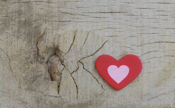 Red heart on wooden with texture background.