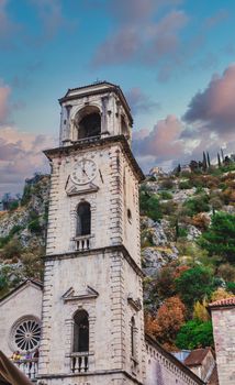 A Stone Clock Tower and Old Buildings in Kotor with Mountain in Background