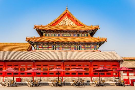 Summer cafe with tables and umbrellas at the wall of one of the royal emperor palace in Forbidden city, Beijing, China