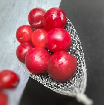 Colorful Red plums kept in fruit cover placed in black background and reduce the risk of cancer heart disease and diabetes