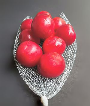Colorful Red plums kept in fruit cover placed in black background and reduce the risk of cancer heart disease and diabetes