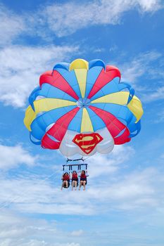 AKLAN, PH - SEPT 11 - Women doing parachute sailing recreational activity at Boracay island on September 11, 2012 in Aklan, Philippines.