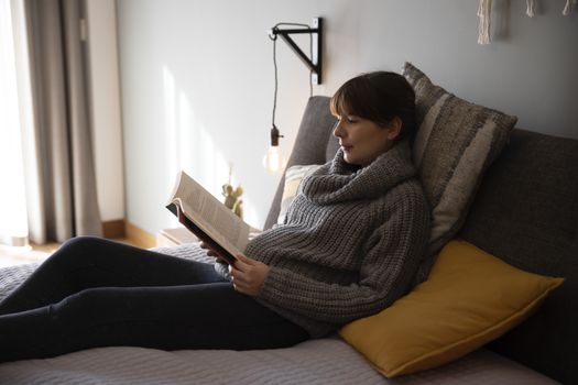 Beautiful woman on bed and reading a book