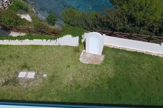 The wicket in the fence to the path of descent to the sea.