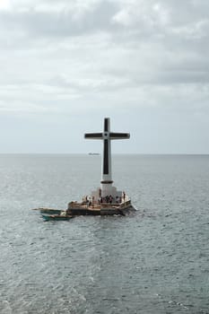 CAMIGUIN, PH - Sunken cemetery cross monument on February 3, 2013 in Camiguin, Philippines.