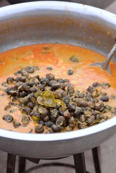 Freshwater snail in red curry  In a large bowl for sale.