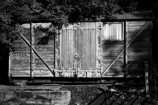 Old railway freight carriage used as a shed black and white image