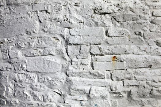 Old fashioned dirty grey painted brick stone wall texture background