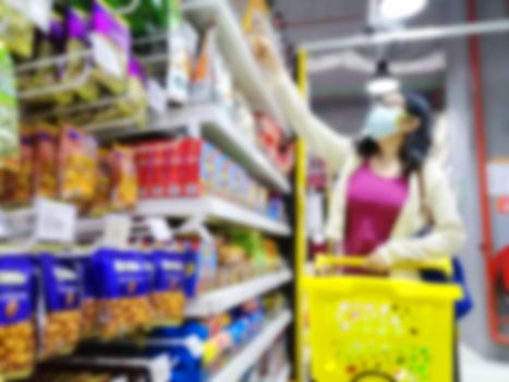 Blurred images of an asian girl  shopping in supermarket due to panic shopping because of Corona-Virus, Covid-19. Business and healthcare concept.