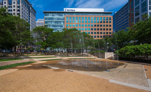 Reston, VA, USA -- May 21, 2019. Photo overlooking Reston Town Center Park, a splash pad and the office buildings surrounding it.