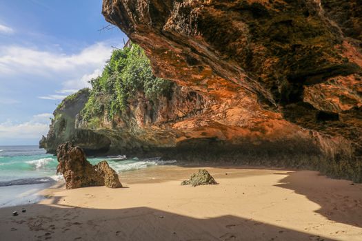 Suluban beach, Bali, Indonesia. Nature vacation background. Colorful sunrise on the rocky coast. Rocs on the beach. Blue ocean. Happy holiday. Vacation