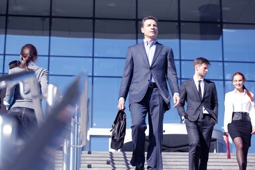 Crowd of diverse business people walking at stairs of company office building