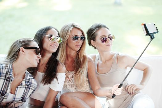 Girls with smartphone taking selfie in park