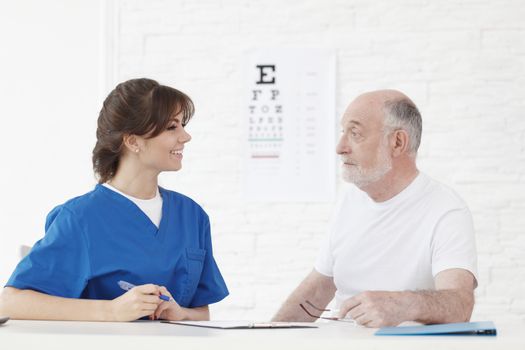 Doctor making vision test for new glasses for senior patient