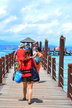 SABAH, MY - JUNE 20: Manukan Island footbridge on June 20, 2016 in Sabah, Malaysia. The Manukan Island Resort is a hideaway that is one of the five tropical islands that comprise the Tunku Abdul Rahman Park.