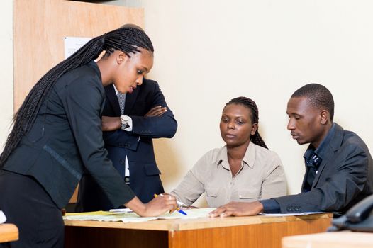 Business people gathered around a table exploit a geographical map