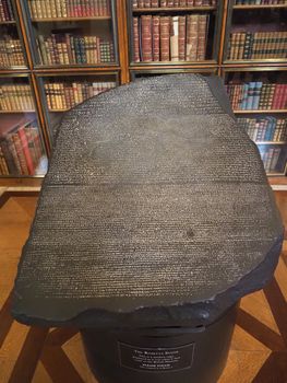 LONDON, UK - CIRCA SEPTEMBER 2019: Rosetta Stone stele replica at the British Museum with text in Ancient Egyptian hieroglyphic, Demotic scripts and Ancient Greek