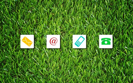 Website and internet contact us concept, customer service, icon on green grass background