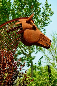 Modern sculpture made of rusty wire; a garden sculpture representing a horse