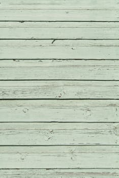 The texture of old scratched green wooden planks. Old painted wood wall texture
