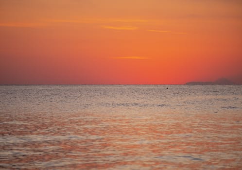 Early morning, dramatic gold sunrise over sea