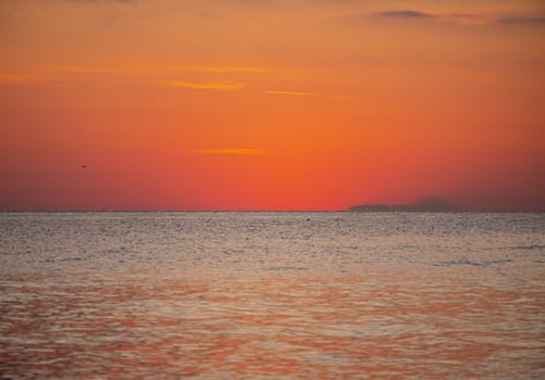 Early morning, dramatic gold sunrise over sea