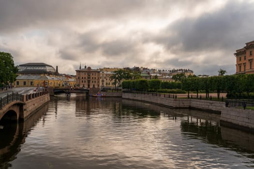 Photo of a canal in St Petersburg in the morning under threatening clouds