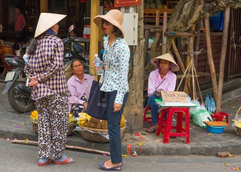 Vietnam -- March 23, 2016 Bargaining over Prices in a Street Market in Vietnam.editorial use only
