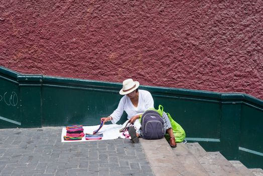 Lima, Peru -- April 13, 2018. A street vendor displays scarves for sale on stairs near the Bridge if Sighs. Editorial use only.