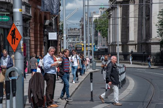 Dublin, Ireland--July 16, 2018.  Pedestrians, tourists, business people fill Dublin's busy streets on a summer afternoon.