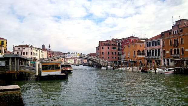 Venice, Italy - 04/24/2019: Foggy (misty) Venice. Canal (channel), historical, old houses and gondoliers with gondolas in thick fog. Scenic cityscape view. Venice. Italy. Copy space. Empty place for message. Outdoor.