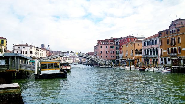 Venice, Italy - 04/24/2019: Foggy (misty) Venice. Canal (channel), historical, old houses and gondoliers with gondolas in thick fog. Scenic cityscape view. Venice. Italy. Copy space. Empty place for message. Outdoor.