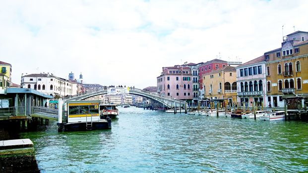 Venice, Italy - 04/24/2019: Foggy (misty) Venice. Canal (channel), historical, old houses and gondoliers with gondolas in thick fog. Scenic cityscape view. Venice. Italy. Copy space. Empty place for message. Outdoor.