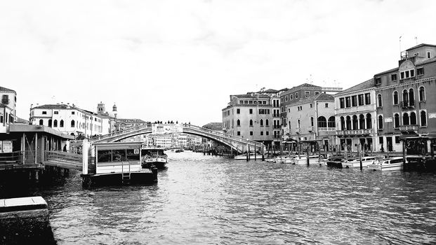 Venice, Italy - 04/24/2019: Foggy (misty) Venice. Canal (channel), historical, old houses and gondoliers with gondolas in thick fog. Scenic cityscape view. Venice. Italy. Copy space. Empty place for message. Outdoor.