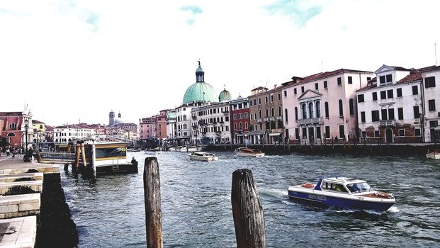 Venice, Italy - 04/24/2019: Foggy (misty) Venice. Canal (channel), historical, old houses and gondoliers with gondolas in thick fog. Scenic cityscape view. Venice. Italy. Copy space. Empty place for message. Outdoor.