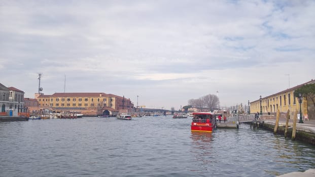 Venice, Italy - 04/24/2019: Foggy (misty) Venice. Canal (channel), historical, old houses and gondoliers with gondolas in thick fog. Scenic cityscape view. Venice. Italy. Copy space. Empty place for message. Outdoor.